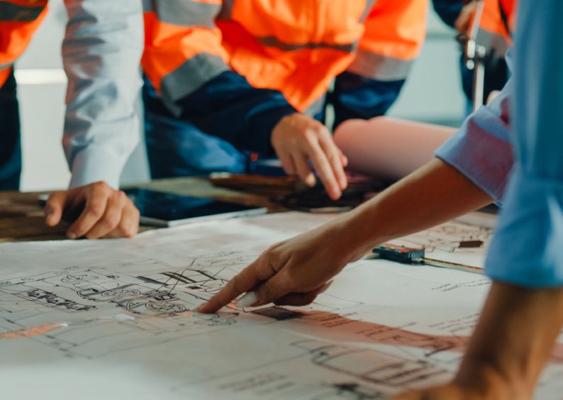 Engineers reviewing construction blueprints.